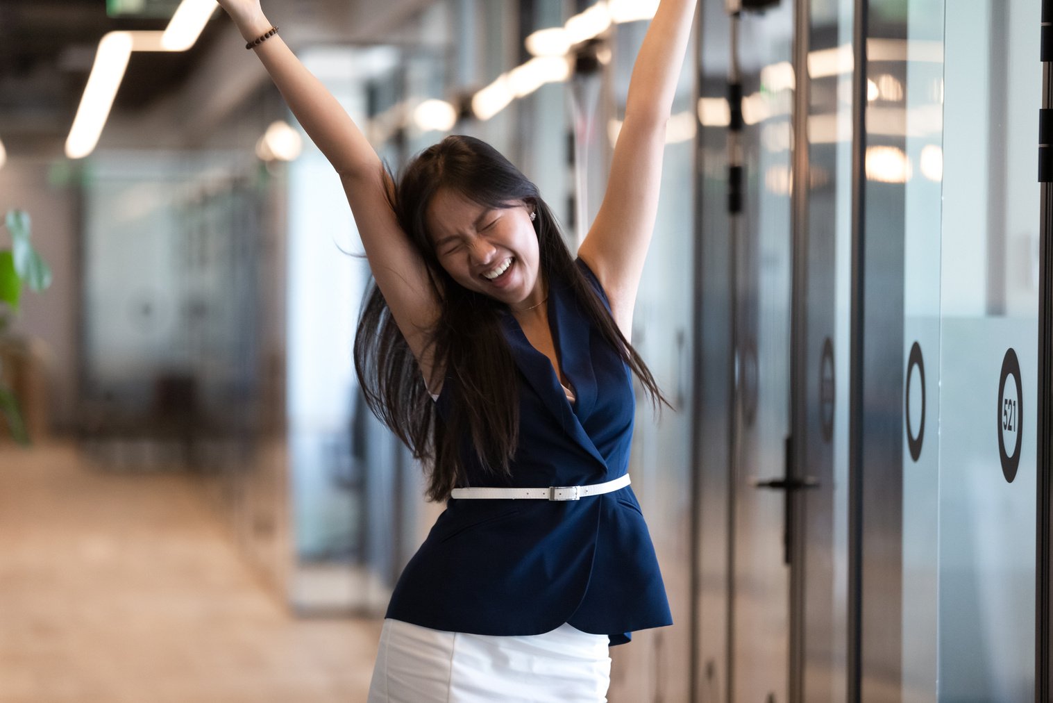 Happy asian businesswoman realized her ambitions celebrating professional achievements